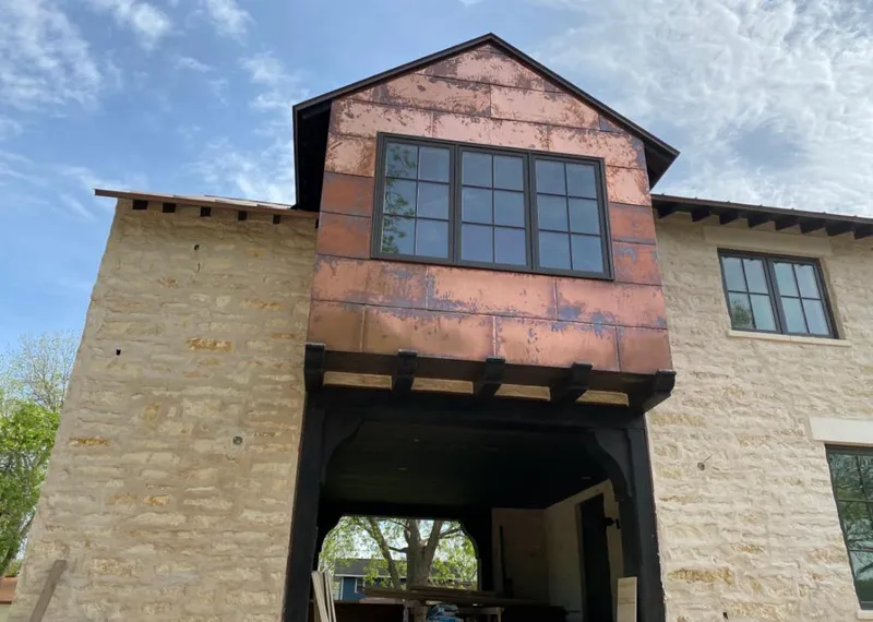Copper metal panel facade on a stone building for Skylight Installation in Burnt Mills